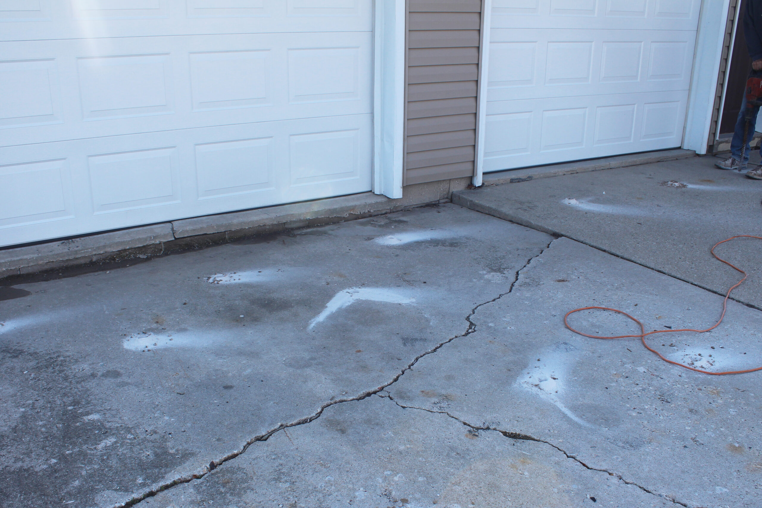 Sunken driveway being prepared for polyurethane concrete lifting in Southeast Idaho
